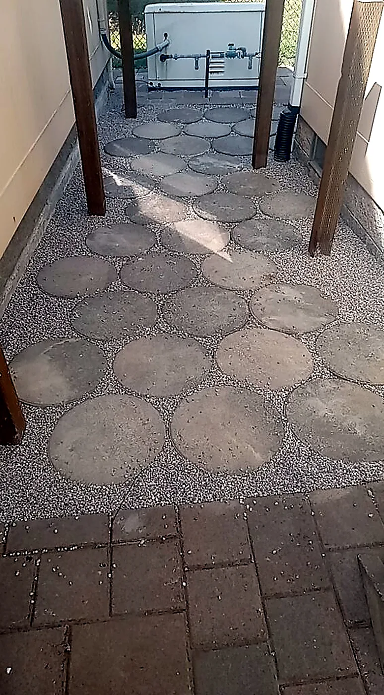 Round paver path set into gravel by SeaBreeze